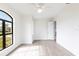 Well-lit bedroom with hardwood floors and an arched window at 16920 Ohara Dr, Port Charlotte, FL 33948