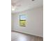 Simple bedroom with hardwood floors and a large window at 16920 Ohara Dr, Port Charlotte, FL 33948
