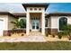 Elegant entryway with double doors and stone accents at 16920 Ohara Dr, Port Charlotte, FL 33948