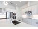 Modern kitchen with white cabinets, stainless steel appliances and quartz countertops at 16920 Ohara Dr, Port Charlotte, FL 33948
