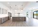 Modern kitchen featuring white cabinets, stainless steel appliances, and a large island at 16920 Ohara Dr, Port Charlotte, FL 33948