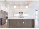 Modern kitchen with white cabinets, stainless steel appliances & large island at 16920 Ohara Dr, Port Charlotte, FL 33948