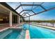 Inviting pool and spa with screened enclosure and water views at 16920 Ohara Dr, Port Charlotte, FL 33948