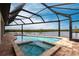 Inviting screened pool and spa with a picturesque waterfront view at 16920 Ohara Dr, Port Charlotte, FL 33948