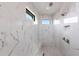 Spa-like shower with marble walls and built-in seating at 16920 Ohara Dr, Port Charlotte, FL 33948
