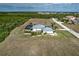 Aerial view of house, pool, and surrounding landscape at 17455 Boca Vista Rd, Punta Gorda, FL 33955