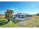 Home with fenced-in pool, patio, and lush landscaping at 17455 Boca Vista Rd, Punta Gorda, FL 33955