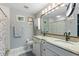 Double vanity bathroom with granite countertops and a shower at 17455 Boca Vista Rd, Punta Gorda, FL 33955