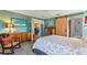 Serene bedroom with a dresser, rocking chair, and a view to another room at 17455 Boca Vista Rd, Punta Gorda, FL 33955