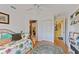 Bedroom with daybed, built-in shelving and access to another room at 17455 Boca Vista Rd, Punta Gorda, FL 33955