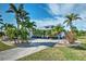 White house with palm trees, driveway, and landscaped lawn at 17455 Boca Vista Rd, Punta Gorda, FL 33955