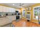 Modern kitchen with white cabinets, granite countertops, and stainless steel appliances at 17455 Boca Vista Rd, Punta Gorda, FL 33955