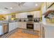 Bright kitchen with stainless steel appliances and granite countertops at 17455 Boca Vista Rd, Punta Gorda, FL 33955