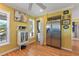 Kitchen features stainless steel refrigerator and laundry closet at 17455 Boca Vista Rd, Punta Gorda, FL 33955