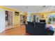 Living room with hardwood floors, yellow walls, and access to a balcony at 17455 Boca Vista Rd, Punta Gorda, FL 33955