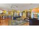 Spacious living area with hardwood floors, yellow walls, and multiple seating areas at 17455 Boca Vista Rd, Punta Gorda, FL 33955