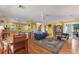 Open living space with hardwood floors, yellow walls, and dining area at 17455 Boca Vista Rd, Punta Gorda, FL 33955