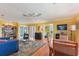 Open living area with hardwood floors, yellow walls, and ample seating at 17455 Boca Vista Rd, Punta Gorda, FL 33955