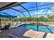 Inviting pool area with screened enclosure, patio furniture, and lush landscaping at 17455 Boca Vista Rd, Punta Gorda, FL 33955