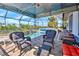 Relaxing wicker furniture near the screened-in pool and spa at 17455 Boca Vista Rd, Punta Gorda, FL 33955