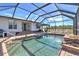 Screened pool and spa with adjacent patio and house access at 17455 Boca Vista Rd, Punta Gorda, FL 33955