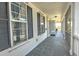 Long covered porch with tile flooring and access to backyard at 17455 Boca Vista Rd, Punta Gorda, FL 33955