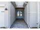 Covered entryway with light-blue double doors and a grey-brick paved walkway at 17709 Wayside Bnd, Punta Gorda, FL 33982