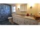 Bright bathroom with a seashell shower curtain and white vanity at 181 Coconut St, Punta Gorda, FL 33980
