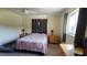 Cozy bedroom featuring a ceiling fan, window, and nightstands with lamps at 181 Coconut St, Punta Gorda, FL 33980
