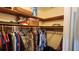 Walk-in closet with wood shelving and ample storage, designed for organization and convenience at 181 Coconut St, Punta Gorda, FL 33980