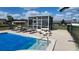 Community pool with lounge chairs, tables, and covered pool and an outdoor shower at 181 Coconut St, Punta Gorda, FL 33980