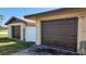 Side angle of two garages with grass and a white fence at 181 Coconut St, Punta Gorda, FL 33980