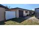 Exterior features of the property, including an attached garage and a white privacy fence at 181 Coconut St, Punta Gorda, FL 33980
