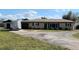 Ranch-style home featuring a large front yard, an attached garage, and a neutral exterior at 181 Coconut St, Punta Gorda, FL 33980