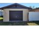 Attached garage with a brown door, offering convenient parking and storage at 181 Coconut St, Punta Gorda, FL 33980