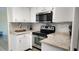 Well-equipped kitchen with sleek stainless steel appliances, modern countertops, and ample cabinet space at 181 Coconut St, Punta Gorda, FL 33980