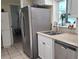 Bright kitchen with stainless steel appliances, granite countertops, and tiled floors at 181 Coconut St, Punta Gorda, FL 33980