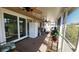 Covered lanai offering additional living space for relaxation and entertaining, with outdoor seating and ceiling fans at 181 Coconut St, Punta Gorda, FL 33980