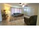 Cozy living room features tile flooring, a ceiling fan, and access to the front entry door at 181 Coconut St, Punta Gorda, FL 33980