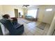 Bright living room with tile flooring, ceiling fan, and large window, creating a warm and inviting atmosphere at 181 Coconut St, Punta Gorda, FL 33980