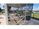 A screened in pool enclosure with table and chairs at 181 Coconut St, Punta Gorda, FL 33980