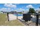Fenced in backyard pool with a pump and covered sitting area with the rest of the backyard in the background at 181 Coconut St, Punta Gorda, FL 33980