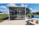 View of a poolside screened enclosure with seating area, partial pool view, and backyard at 181 Coconut St, Punta Gorda, FL 33980
