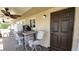 The covered porch has a table with chairs, a ceiling fan, and view to a backyard at 181 Coconut St, Punta Gorda, FL 33980