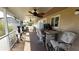The covered porch has a table with chairs and view to a backyard at 181 Coconut St, Punta Gorda, FL 33980