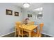 Dining area featuring a light wood table and chairs with a large mirror on the wall at 19505 Quesada Ave # O104, Port Charlotte, FL 33948