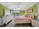Main bedroom with a pink bed, white dresser, and pool view at 20 Medalist Cir, Rotonda West, FL 33947