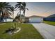 Single-story house with palm trees at 20 Medalist Cir, Rotonda West, FL 33947
