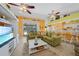 Open-concept living space with green sofas and kitchen views at 20 Medalist Cir, Rotonda West, FL 33947