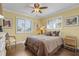 Cozy bedroom with wood floors, window shutters, and a comfortable bed at 2198 El Cerito Ct, Punta Gorda, FL 33950